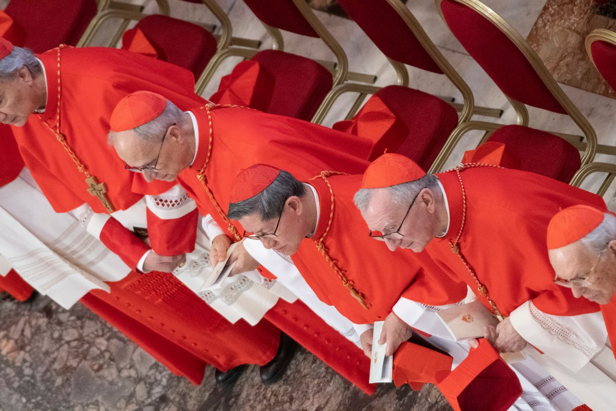 cardinals paying their respects and walking next to the coffin of late Pope Francis at the St Peter's Basilica, during a ceremony following the procession of the late Pope's coffin from the chapel of Santa Marta to St Peter's Basilica in The Vatican