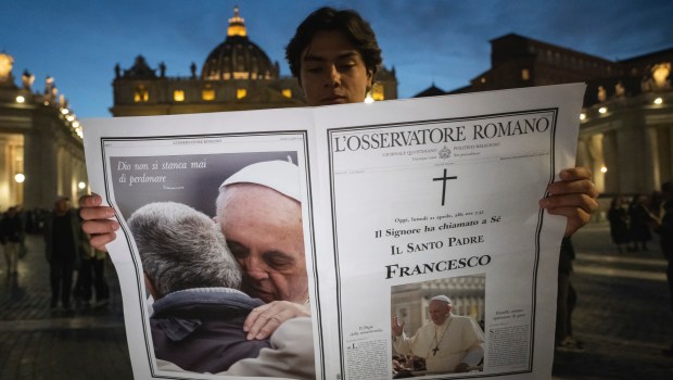 A man holds a special edition of the Vatican newspaper L'Osservatore Romano announcing the death of Pope Francis, in St. Peter's Square