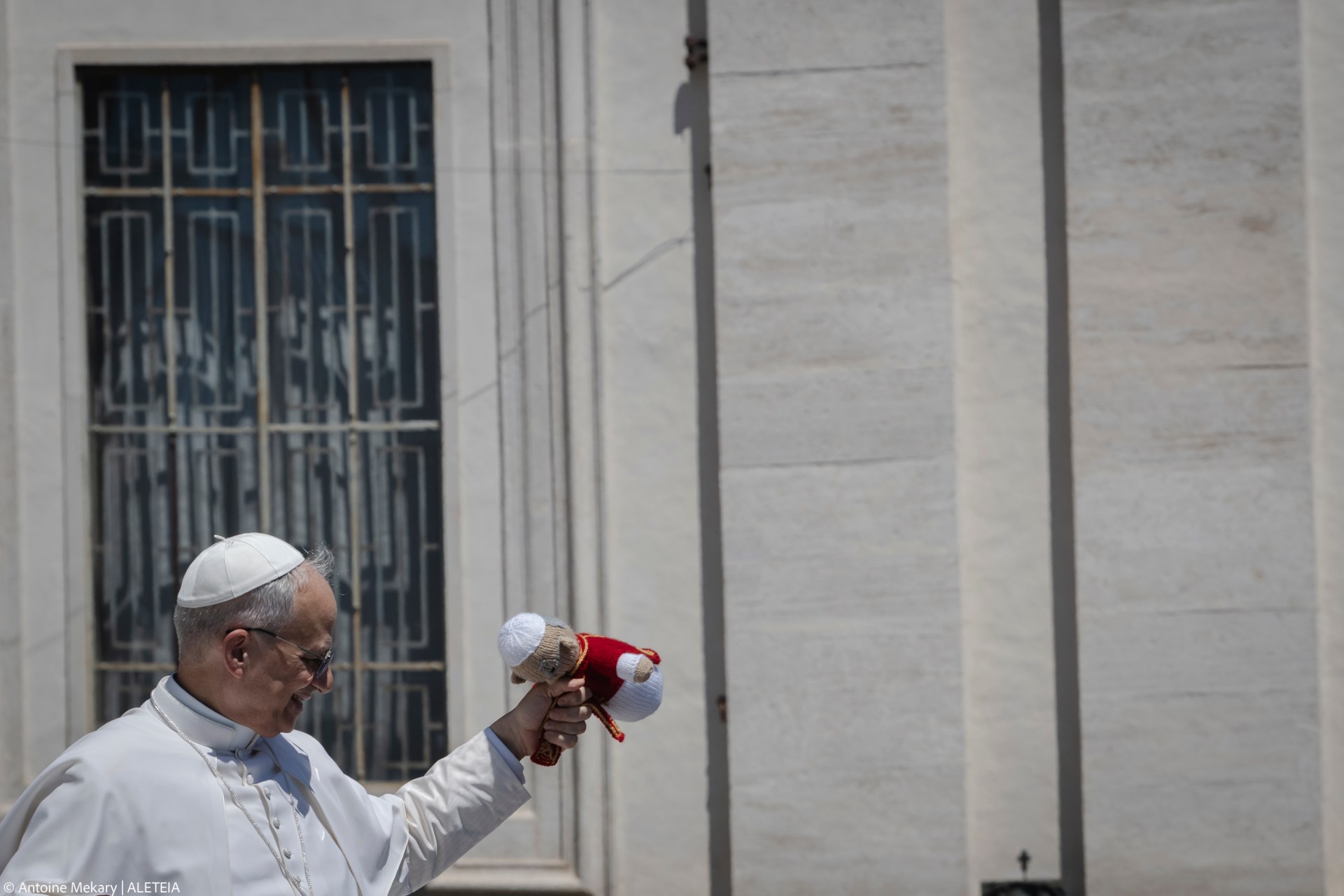 Pope Leo XIV grab a puppet launched by a faithful as he leaves on a popemobile after the weekly general audience at St Peter's Square at The Vatican, on May 28, 2025.