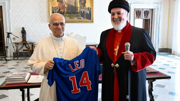 Pope Leo and Mar Awa III with Pope Leo holding a Cubs jersey.