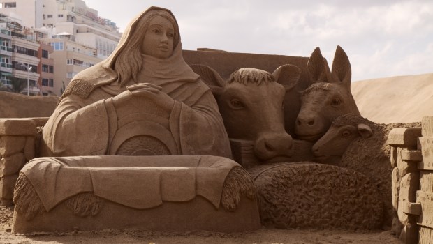 Las Palmas de Gran Canaria, Spain - December 13: Visitors admire Belen de Arena, Nativity scenes made of sand, on Las Canteras town beach, December 13, 2021 in Las Palmas de Gran Canaria, Spain