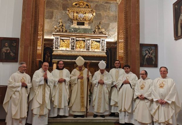 sacerdotes ante el sepulcro de san Juan de la Cruz en segovia