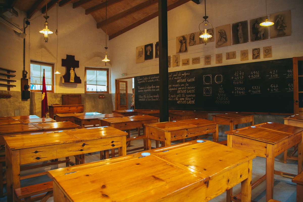 Empty classroom with chairs and desks at the Gaudi school near Sagrada Familia cathedral in Barcelona, Spain.