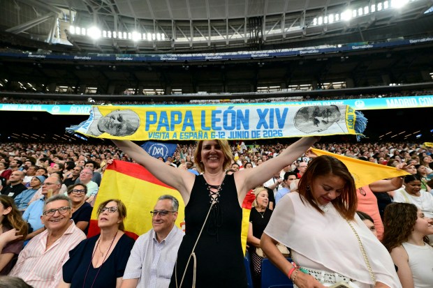 Spectators-cheer-as-Pope-Leo-XIV-arrives-at-Real-Madrids-Santiago-Bernabeu-stadium-in-Madrid