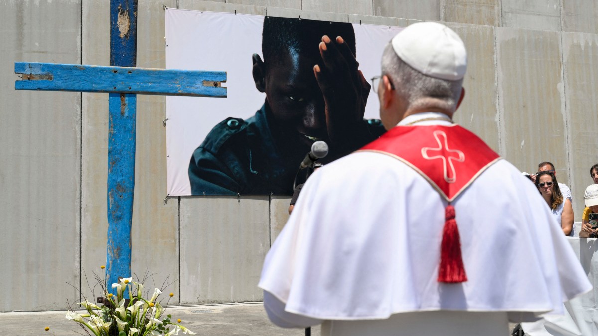 ope Leo XIV blessing a cross made of wood from migrant boats during his meeting with organizations working with migrants in the port of Arguineguin on the Canary Island of Gran Canaria