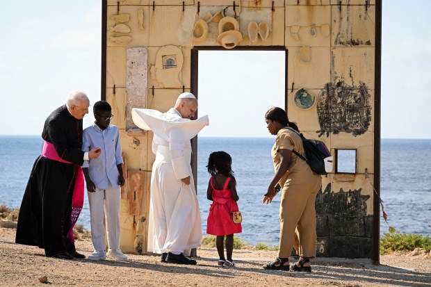 Pope Leo XIV walks trough the arch of the monument Door of Europe - Porta d'Europa made by the italian artist Mimmo Paladino, during a one day visit to Lampedusa island, south of Sicily, on July 4, 2026.